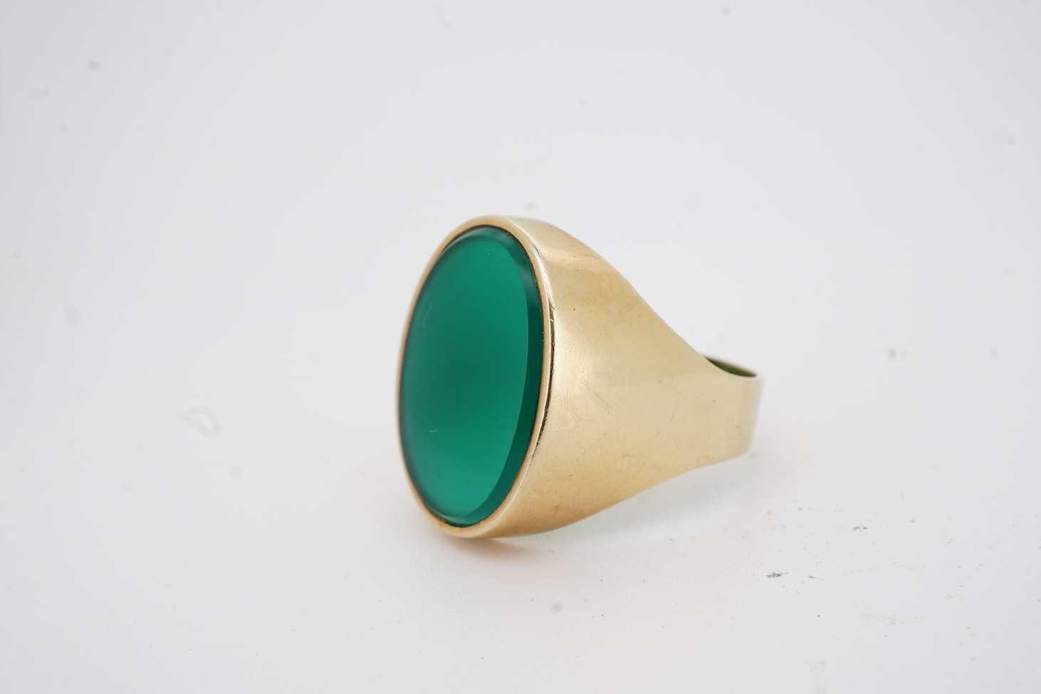 A yellow metal (stamped 585) and single stone oval chrysoprase set signet ring, size U, gross weight 8.4 grams.